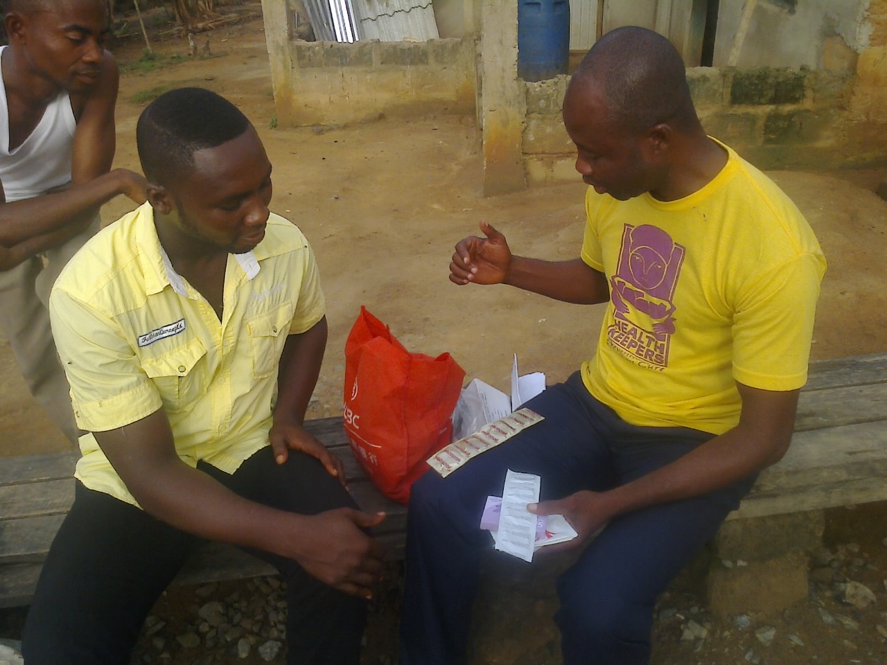 Photo of Nana Akorlegah educating his male colleagues in his community on the use of condoms.