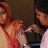 Photo of a woman receiving an injection in her shoulder