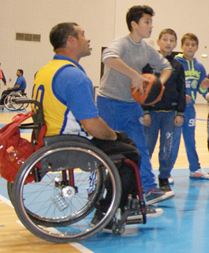 Photo of people playing wheelchair basketball.