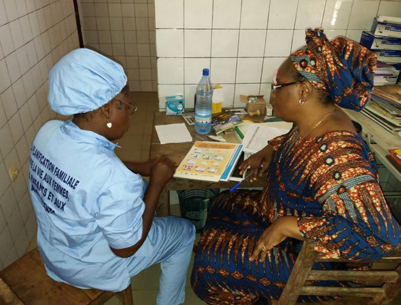Photo of two women reviewing literature at a clinic.