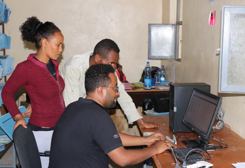 Photo of Negash and his colleagues using Health Net at a local facility. 