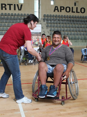 Photo of Marius in a wheelchair on a basketball court.