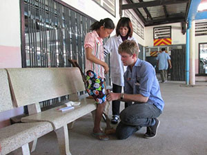 Photo of Srey Norng being fitted for her prosthetic