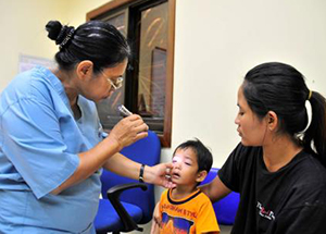  Ms. Channy, AHC refraction nurse, conducts a preliminary diagnosis of Sok Samaky’s eye health. This grant supported additional training for Ms. Channy, improving her ability to diagnose and manage eye diseases in children.