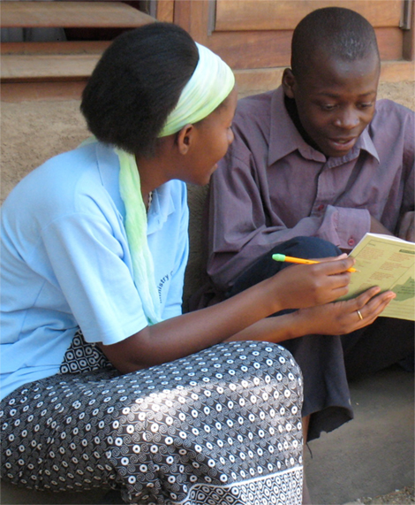 Photo of a girl and boy looking at a booklet