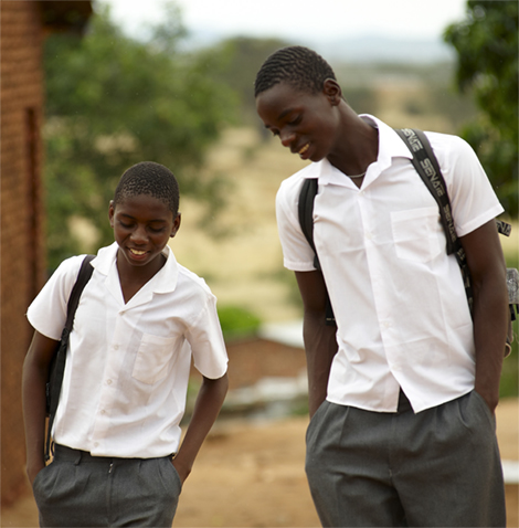 Photo of two boys walking with backpacks