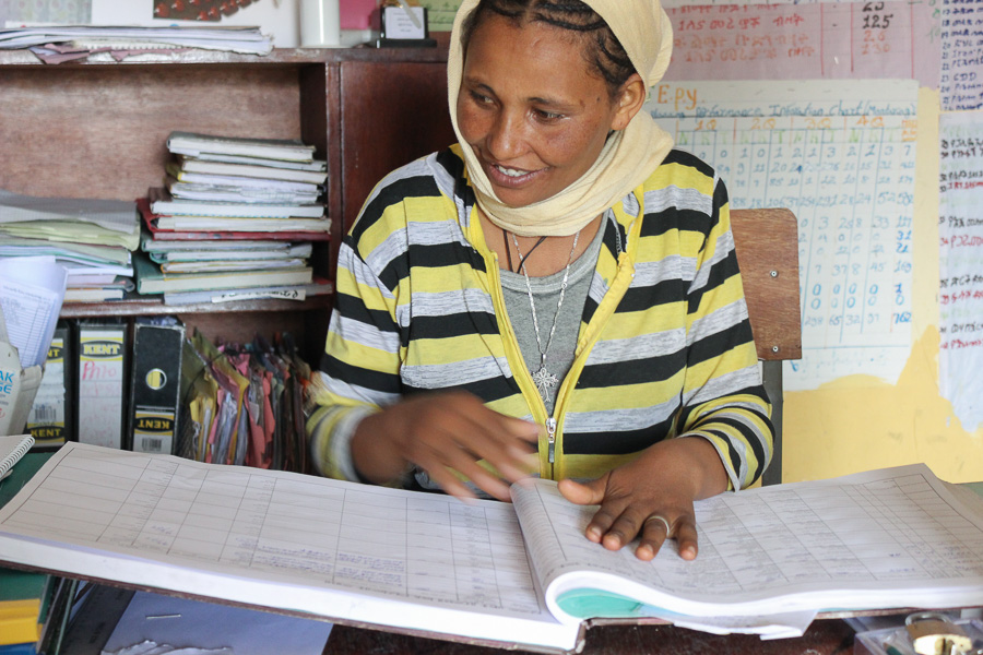 Photo of Alemnesh Assefa at work at a desk