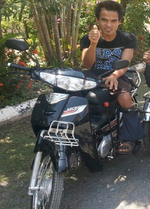 Photo of Hoeun Chan giving thumbs up on a motorbike
