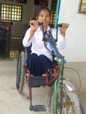 Photo of Hout Thoeung on a tricycle with hand cranks
