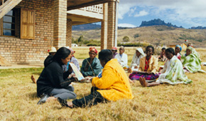 Photo of people meeting in a field.