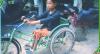 Photo of Hout Thoeung on a tricycle with hand cranks