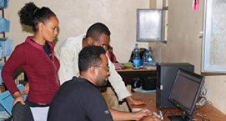Photo of Negash and his colleagues using Health Net at a local facility.
