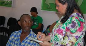 Regional Health Service personnel going over the satisfaction survey with a patient in the Hospital Doctor Antonio Musa, in San Pedro de Macoris.