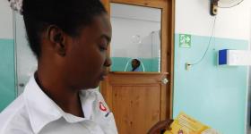 Ramona, a navegadora for Haitian clients, reviews a pamphlet in Creole.