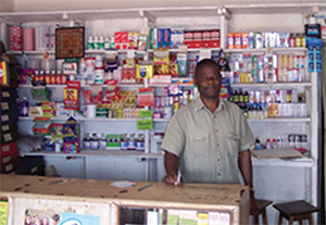Photo of a man behind a drug store counter.